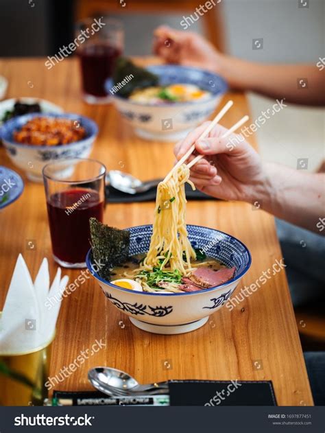 Female With Chopsticks Eating Asian Japanese Shio Ramen Noodle Soup