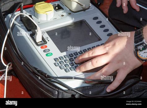 Electrician Using Pat Portable Appliance Testingtesting Machine