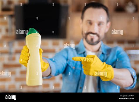 Glad male cleaner showing cleanser Stock Photo - Alamy