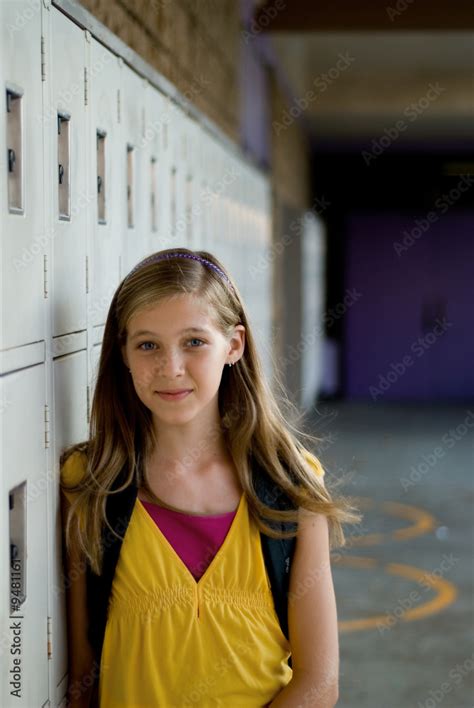 Cute Preteen Teen Or Tween Blonde Standing Against Her Locker Stock