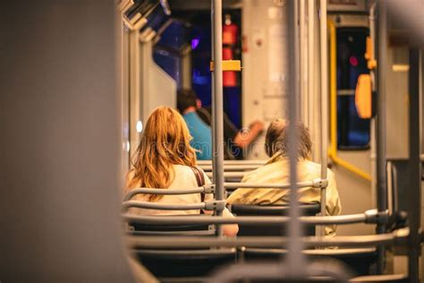 Back View Shot Of Two Female Passengers Sitting On A Metro Train Seats