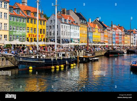 Nyhavn harbor and promenade in Copenhagen, Denmark. Nyhavn is the most ...