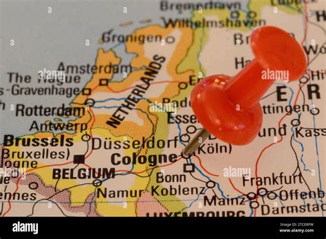 A Red Pin Stuck Into A Map Of Western Europe Pinpointing The Location