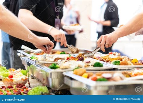 Hands Picking Up Food From Buffet Catering Table At The Party Stock