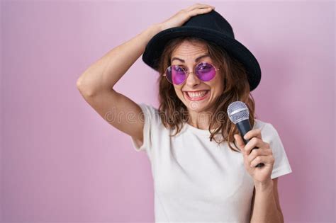Beautiful Brunette Woman Singing Song Using Microphone Stressed And