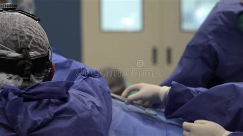 Surgeon Doctor Operating Wearing Special Lamp Lighting Using Electric