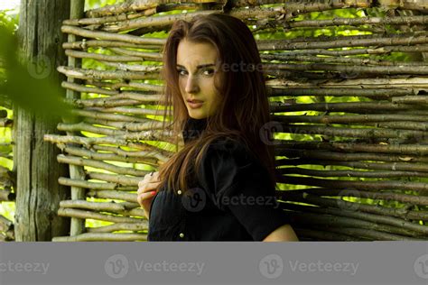 Cutie Brunette Woman In Black Jacket Posing On Camera At The Fence Stock Photo At Vecteezy