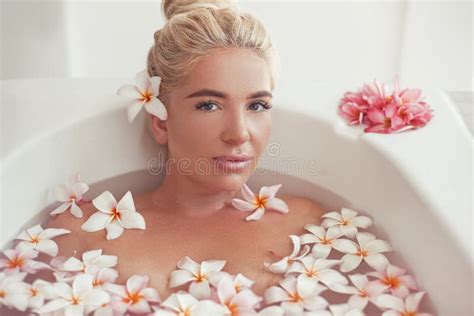 Spa Relax Blonde Enjoying Bath With Plumeria Tropical Flowers Health And Beauty Stock Image