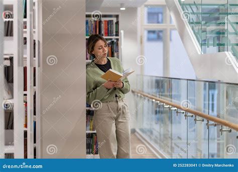 Focused Pensive Mature Woman Bookworm Reading Book In Library Lifelong