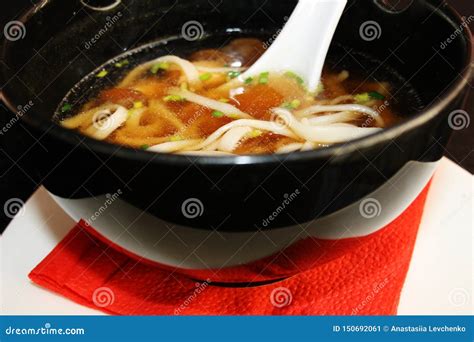 Japanese Cuisine Miso Soup With Udon Noodles On White Plate Stock