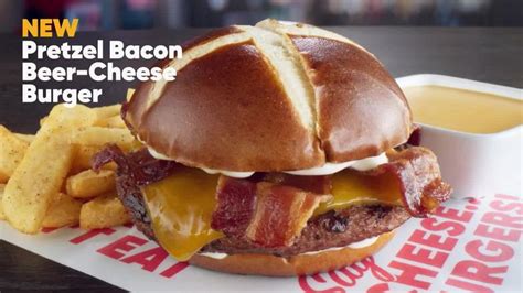 A Bacon Cheeseburger And Fries On A Tray With The Words New Pretzel