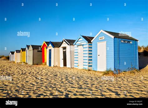 The Famous Colourful Southwold Beach Huts Against A Bright Vibrant Blue