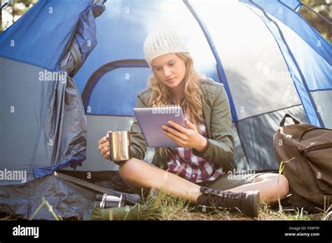Pretty Blonde Camper Using Tablet And Holding Cup Stock Photo Alamy