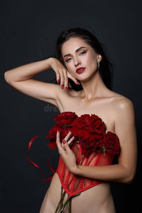 Beautiful Brunette Woman With A Bouquet Of Red Rose Flowers In Red Corset Long Hair Nude Slim