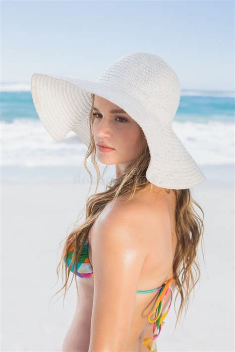 Beautiful Girl On The Beach Posing In White Straw Hat And Bikini Stock