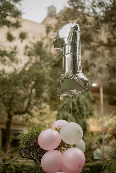 Silver Number 1 Balloon and Pink Balloons Tied Together for the 1st Birthday Celebration · Free ...