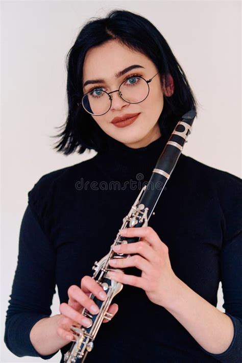 Graceful Brunette Musician Posing With Clarinet On White Background Stock Photo Image Of