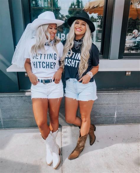 Two Women Dressed In Matching Outfits Posing For The Camera