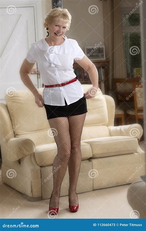 Elderly Woman Standing In A Short Skirt Stock Image Image Of Room