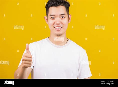 Man Smiling Positive Showing Thumbs Up Gesture Stock Photo Alamy