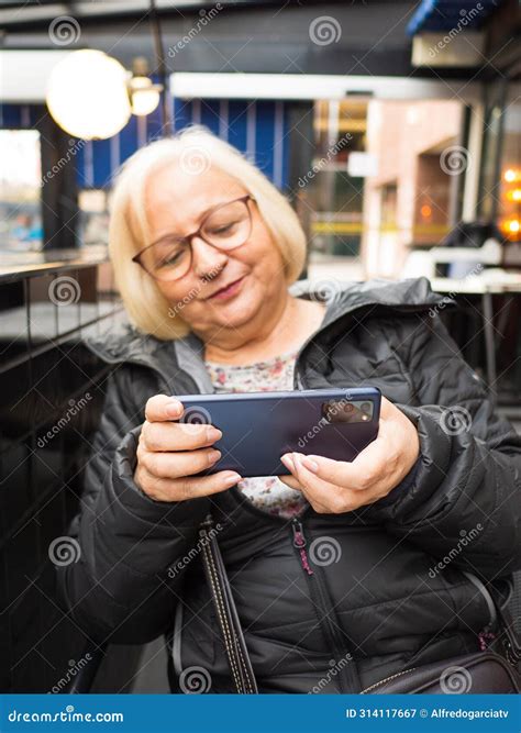 Defocused Blonde Gamer Grandma Concentrated Playing On Smartphone Stock Image Image Of