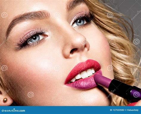 Beautiful Woman Colors Lips With Red Lipstick Makeup Stock Photo