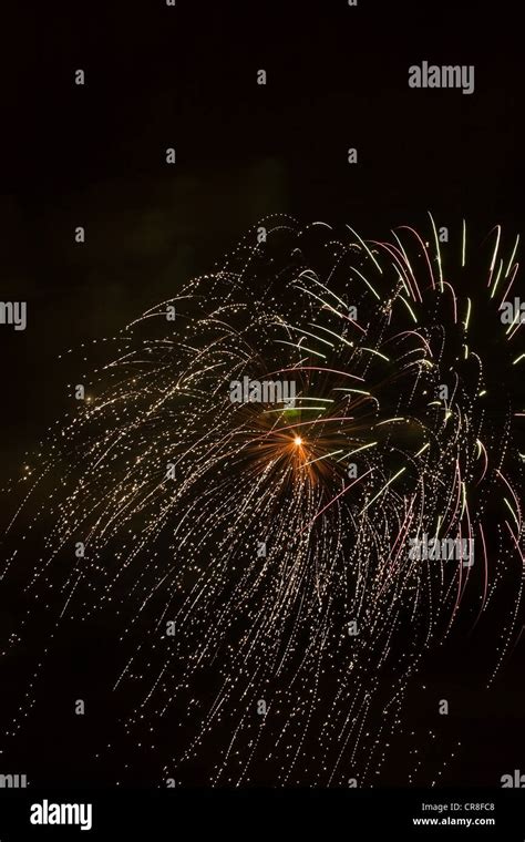 Fireworks exploding against night sky Stock Photo - Alamy