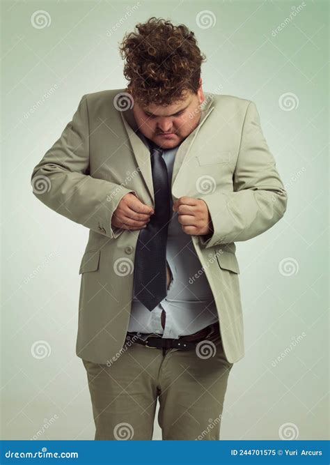 How Is This Done Shot Of An Overweight Man In A Suit Trying To Button