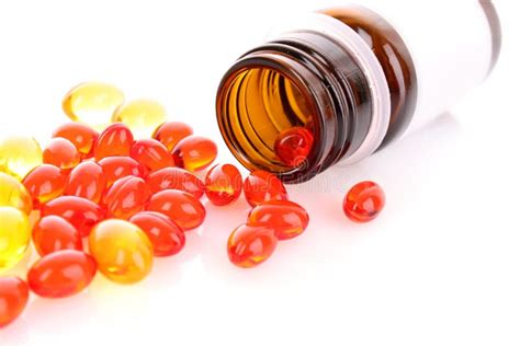 Red And Yellow Capsules Of Vitamins On The Hand Stock Photo Image Of