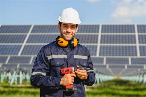 Technician Worker Installing Solar Panels At Solar Cell Farm Stock