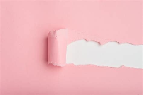 Premium Photo Torn Pink Paper Revealing White Background Texture