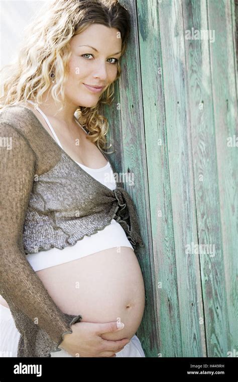 Woman Young Pregnant Touch Belly Wall Lean Half Portrait