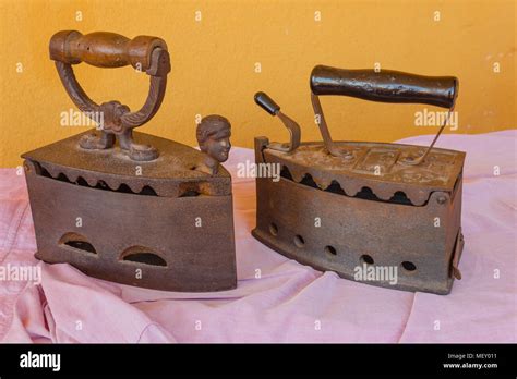 Two Old Irons Made Of Cast Iron On A Shirt Stock Photo Alamy