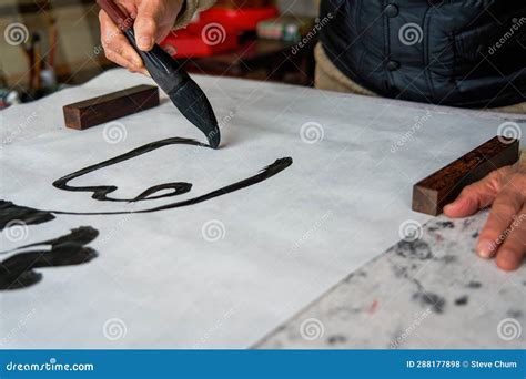 An Old Chinese Calligrapher Is Creating And Writing Calligraphy Works