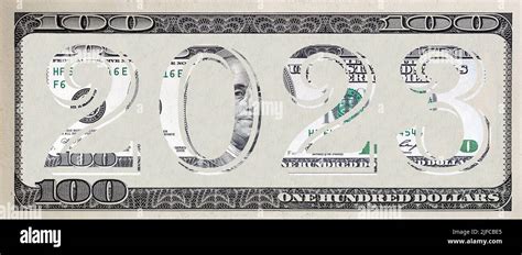 The inscription 2023 made of 100 dollar banknote on 100 dollar banknote ...