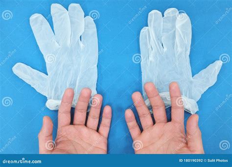 Bare Hands And Gloves In Blue Desk Background Top View Flat Lay Stock