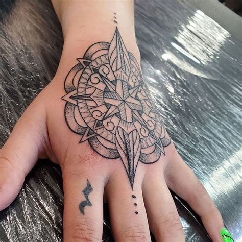 A Person S Hand With A Tattoo On It And A Star In The Middle