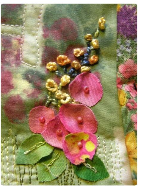 A Close Up View Of Some Flowers On A Piece Of Fabric With Bead Work