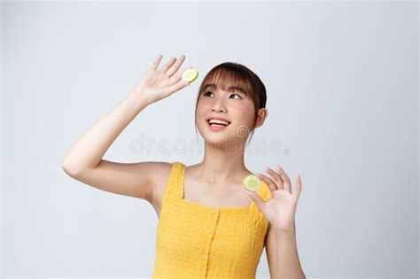Cheerful Woman With Naked Shoulders Holding Sliced Fresh Cucumbers