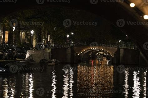 amsterdam canals cruise at night 20233678 Stock Photo at Vecteezy