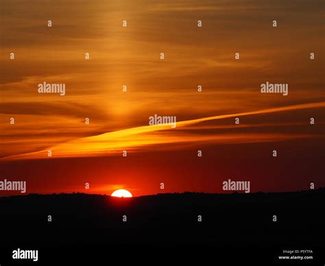 Rare Sun Pillar Cirrus Cloud Phenomenon Above A Vivid Sunset Over