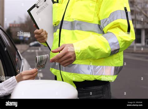 Woman Giving Bribe To Police Officer Out Of Car Window Closeup Stock