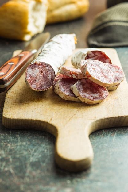 Premium Photo Tasty Sliced Salami With White Mold On Cutting Board