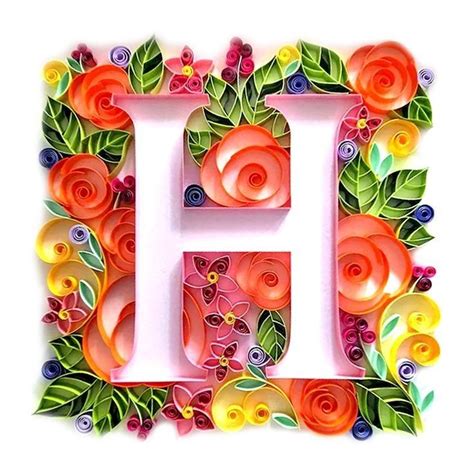 The Letter H Is Made Up Of Paper Flowers Leaves And Swirls On It