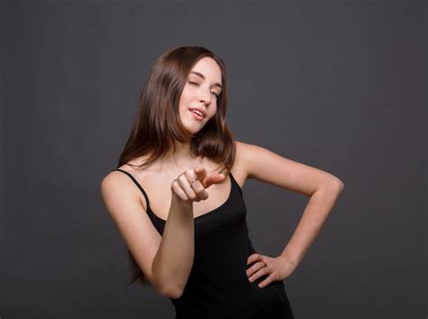 Premium Photo Smiling Woman Wink And Pointing To Camera Attractive