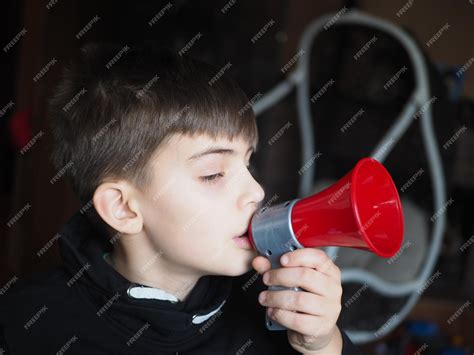 Premium Photo Boy With A Megaphone In His Mouth