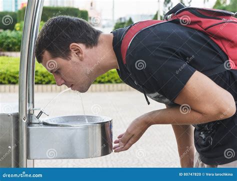 Man Drink Water From Drinking Fountain At Street Stock Photo Image Of