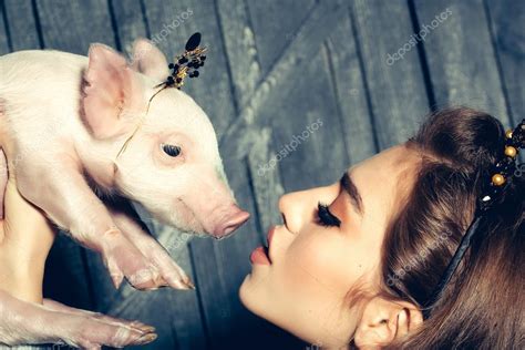 Woman with pig Stock Photo by ©Tverdohlib.com 101470536