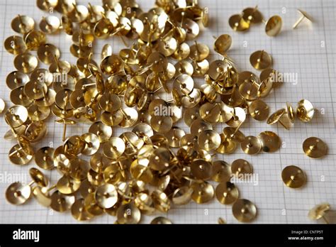 Close Up Of Gold Thumbtacks Stock Photo Alamy