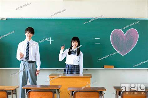 Japanese High School Students In Front Of Classroom Blackboard Stock